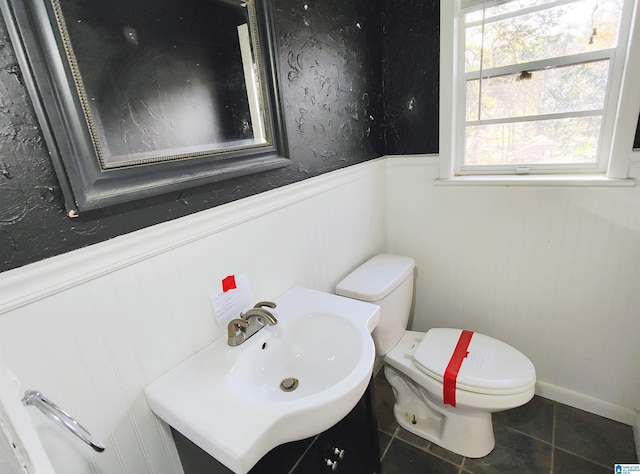 bathroom featuring tile patterned flooring, vanity, and toilet