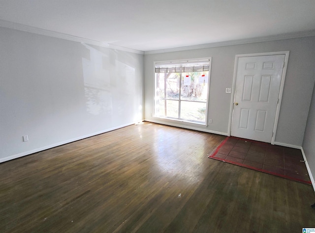 spare room with crown molding and dark hardwood / wood-style flooring