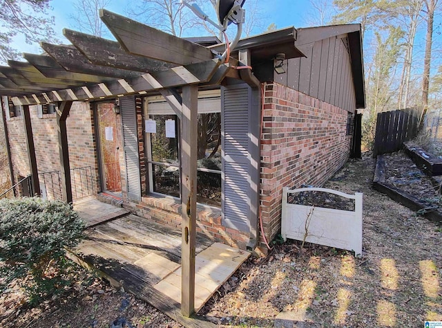 view of exterior entry featuring a pergola