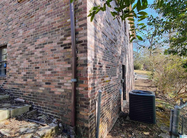 view of side of home featuring central AC