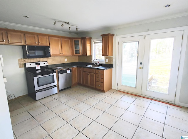 kitchen featuring crown molding, stainless steel appliances, and sink