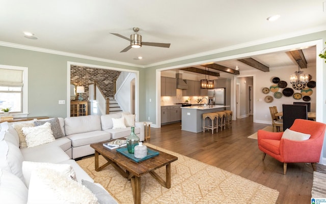 living room with crown molding, ceiling fan with notable chandelier, dark hardwood / wood-style floors, and beamed ceiling