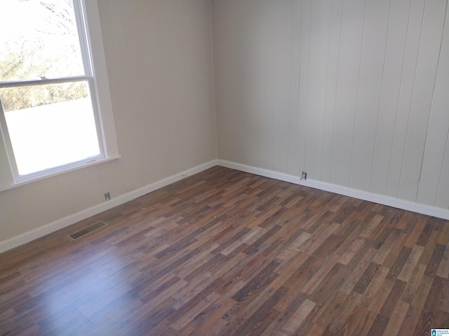 unfurnished room featuring dark wood-type flooring