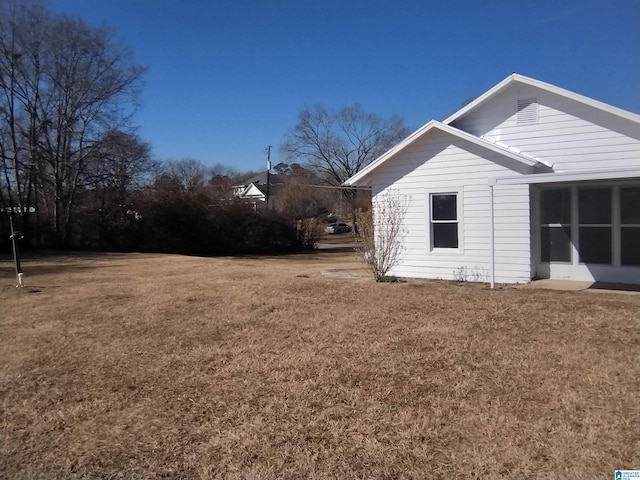 view of property exterior with a lawn