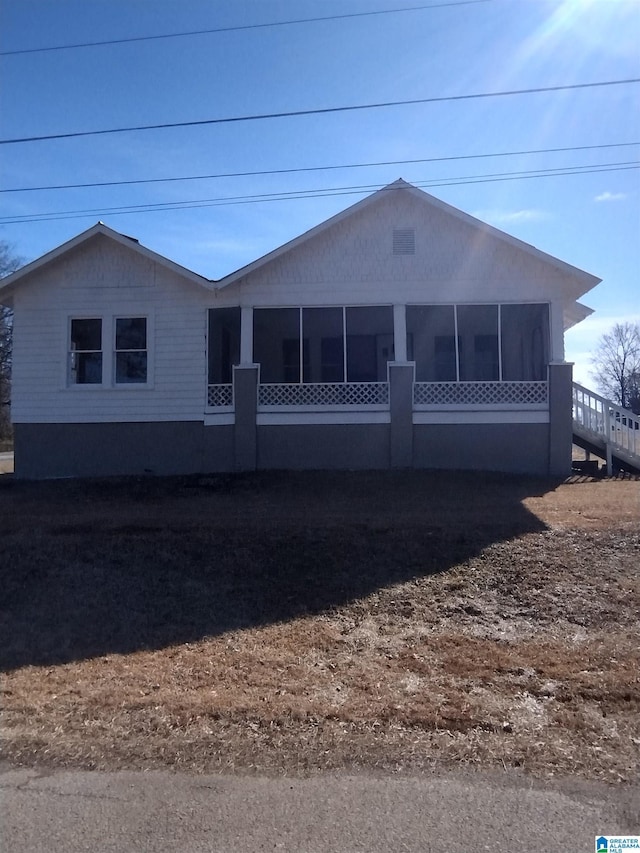 view of front of house featuring a sunroom