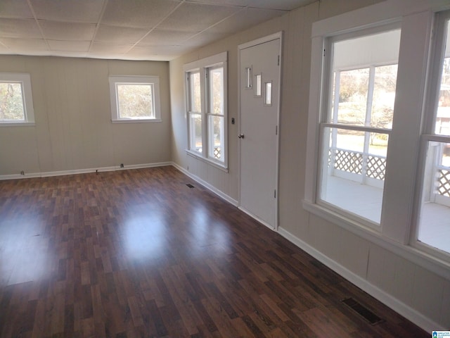 entryway featuring plenty of natural light, dark wood-type flooring, and a paneled ceiling