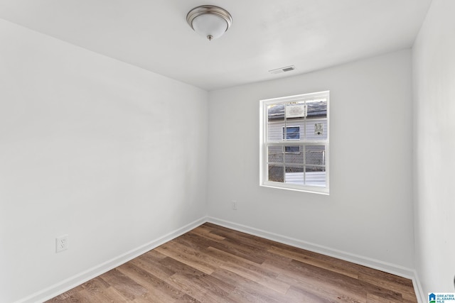 spare room with hardwood / wood-style flooring