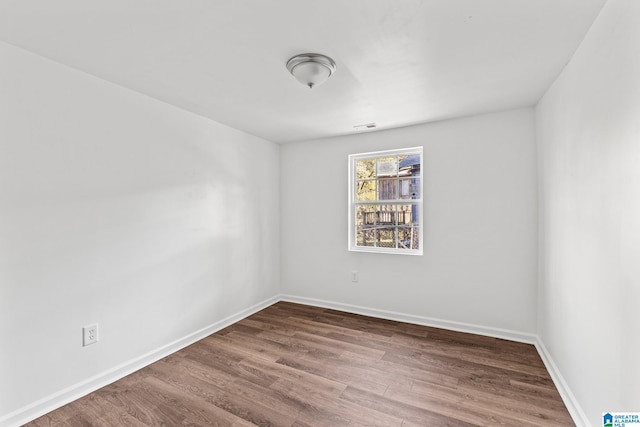 unfurnished room featuring hardwood / wood-style flooring