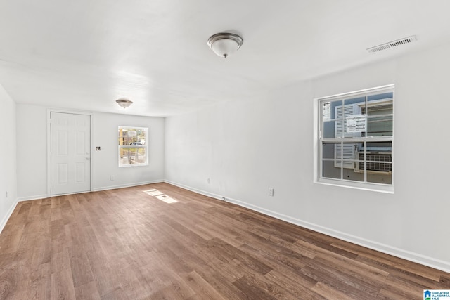 empty room with hardwood / wood-style flooring