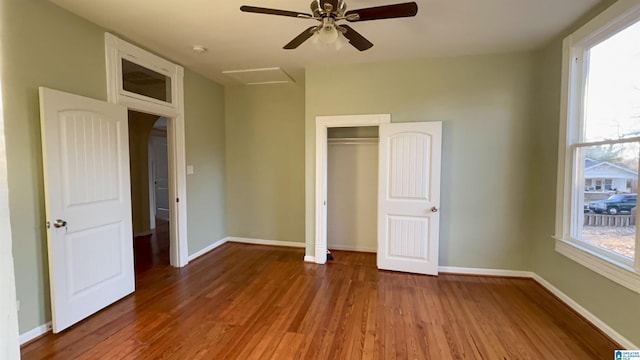 unfurnished bedroom featuring hardwood / wood-style flooring, ceiling fan, and a closet