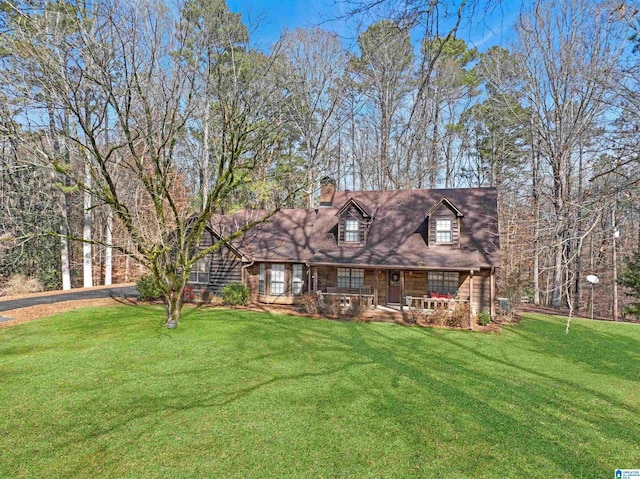 cape cod home with covered porch and a front lawn