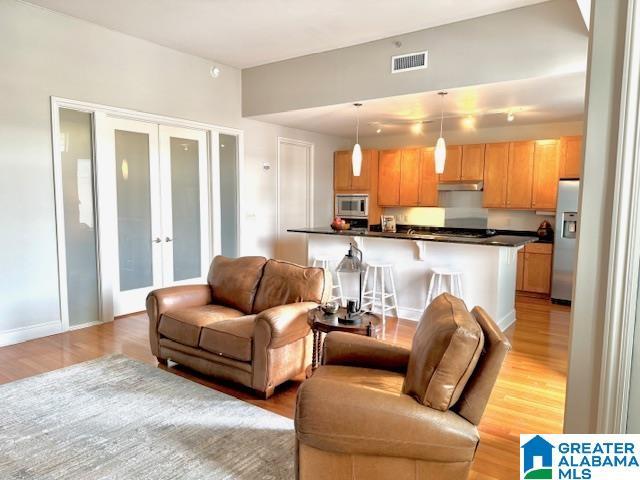 living room featuring light hardwood / wood-style floors and french doors