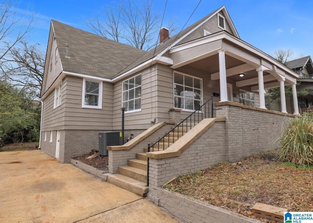 view of front of house with central AC unit and covered porch