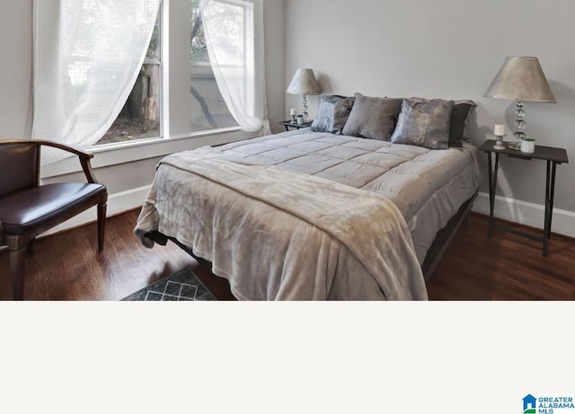 bedroom featuring dark hardwood / wood-style flooring and multiple windows