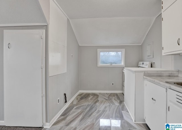 clothes washing area with washer / clothes dryer and a textured ceiling