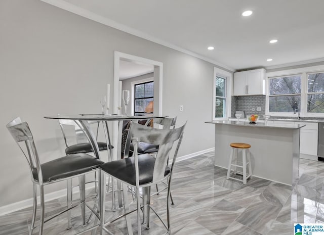 dining space with ornamental molding