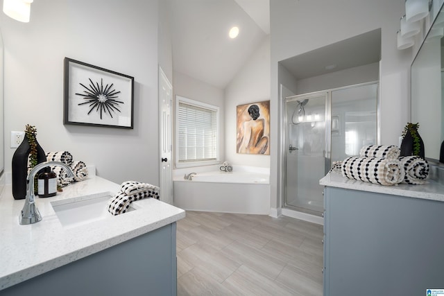 bathroom featuring lofted ceiling, vanity, and plus walk in shower