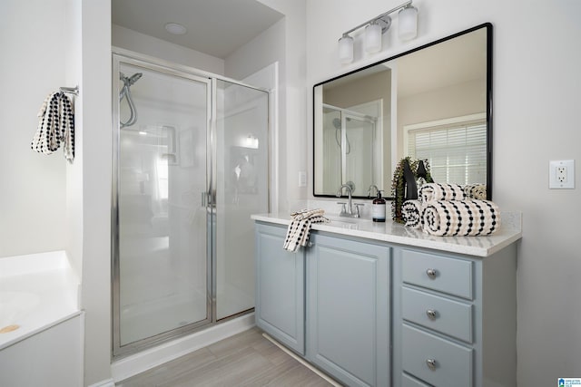 bathroom featuring vanity and an enclosed shower