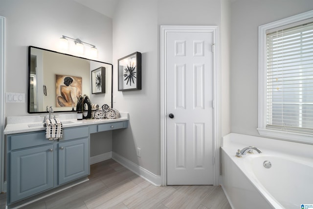 bathroom with a tub to relax in and vanity