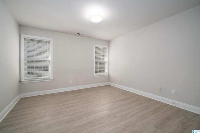 spare room featuring light wood-type flooring