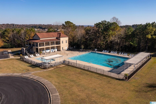 view of swimming pool featuring a patio and a lawn