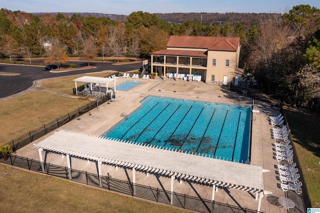 view of swimming pool with a patio area and a pergola