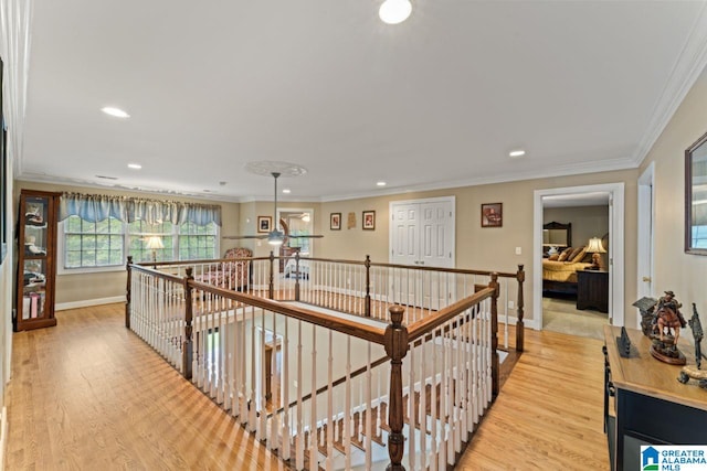 hall featuring crown molding and light wood-type flooring