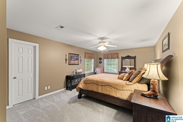 bedroom featuring light colored carpet and ceiling fan