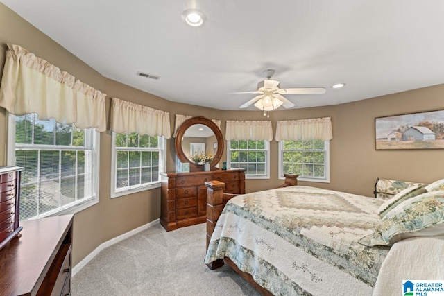 bedroom with ceiling fan and light carpet