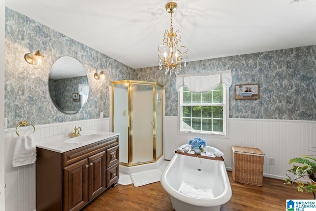 bathroom featuring wood-type flooring, separate shower and tub, and vanity