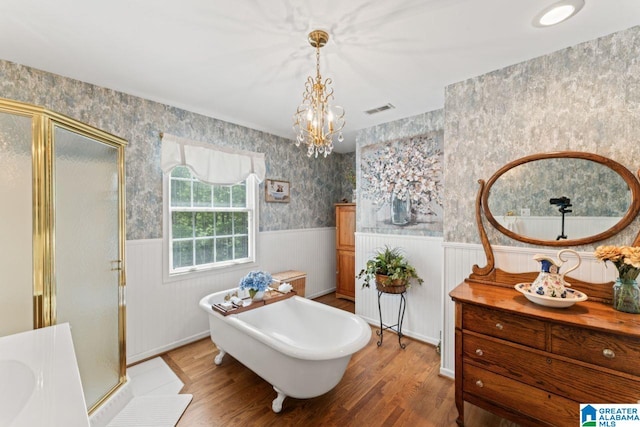 bathroom with independent shower and bath, vanity, and hardwood / wood-style floors