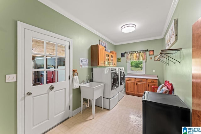 laundry area with crown molding, cabinets, and washer and dryer