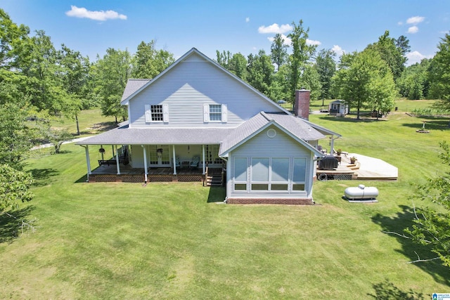 back of house with a wooden deck, covered porch, and a lawn