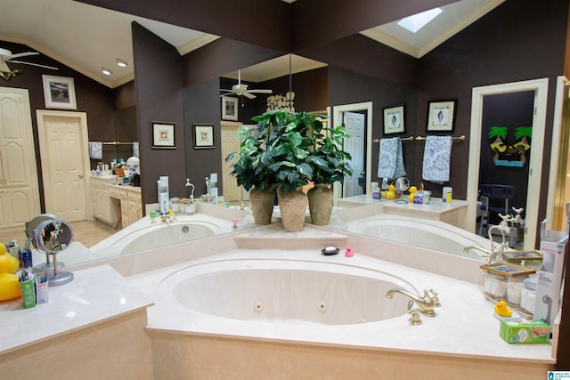 bathroom featuring lofted ceiling with skylight, crown molding, ceiling fan, and a tub to relax in