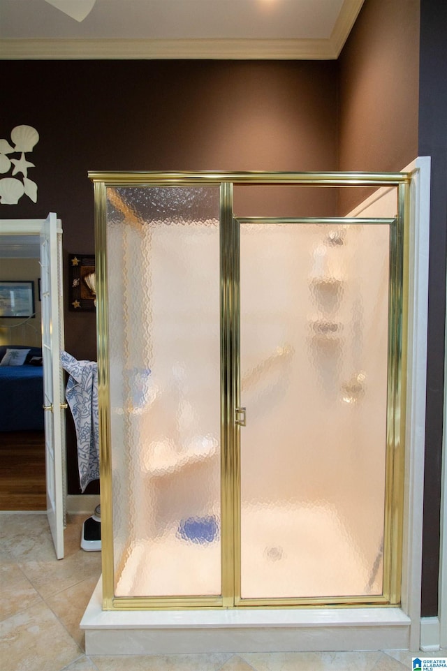 bathroom featuring crown molding, tile patterned floors, and a shower with shower door