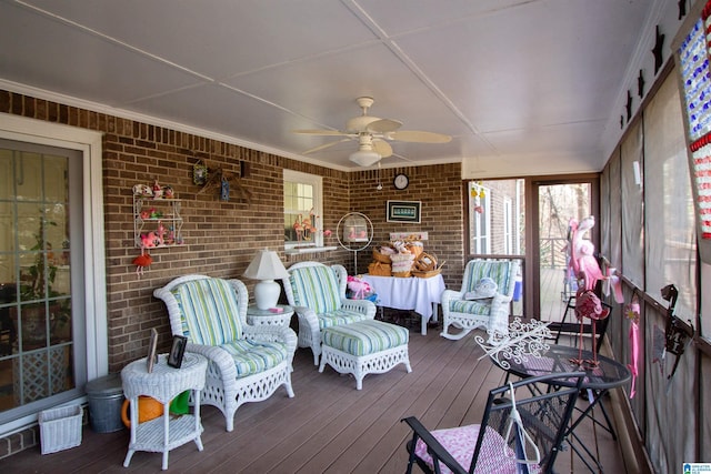 sunroom / solarium featuring ceiling fan