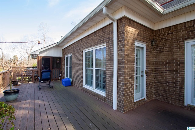 wooden deck featuring a sunroom