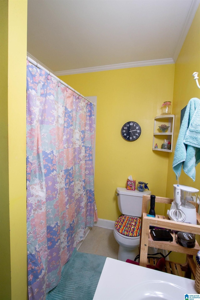 bathroom featuring ornamental molding, toilet, and tile patterned flooring