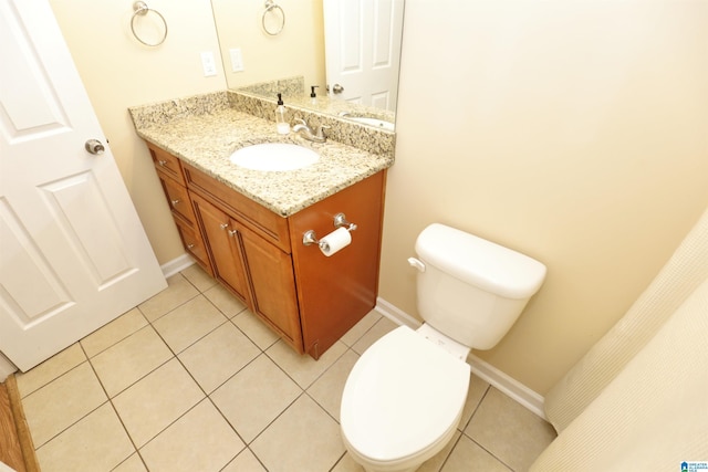 bathroom featuring vanity, tile patterned flooring, and toilet