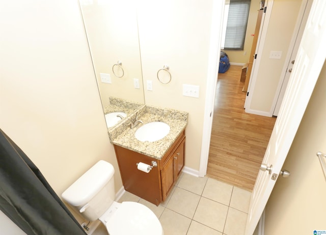 bathroom featuring vanity, tile patterned flooring, and toilet