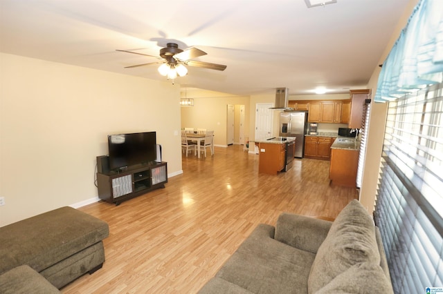 living room with light hardwood / wood-style flooring and ceiling fan