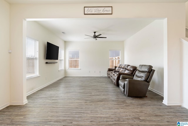 living room with wood-type flooring and ceiling fan