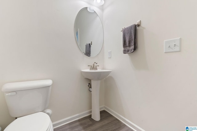 bathroom featuring hardwood / wood-style floors and toilet