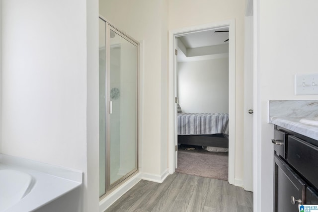 bathroom with vanity, hardwood / wood-style floors, and walk in shower