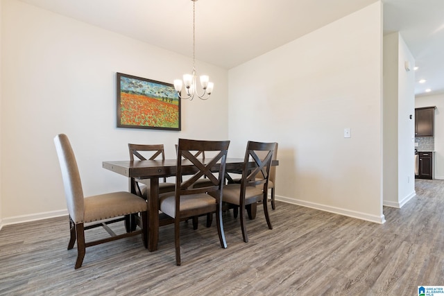 dining space with an inviting chandelier and hardwood / wood-style floors