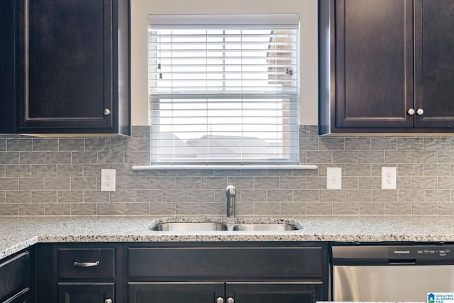 kitchen featuring tasteful backsplash, dishwasher, sink, and a healthy amount of sunlight