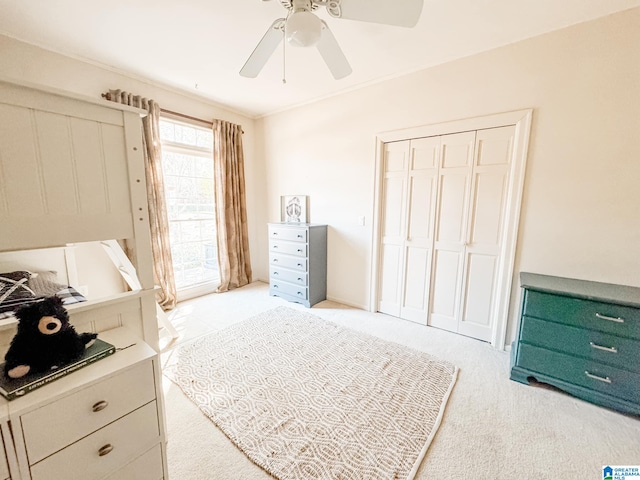 bedroom featuring crown molding, a closet, and ceiling fan