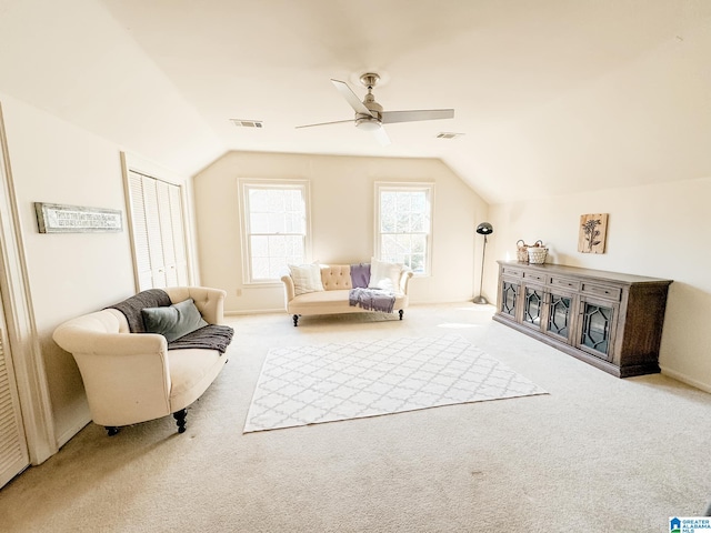 sitting room with ceiling fan, light colored carpet, and lofted ceiling