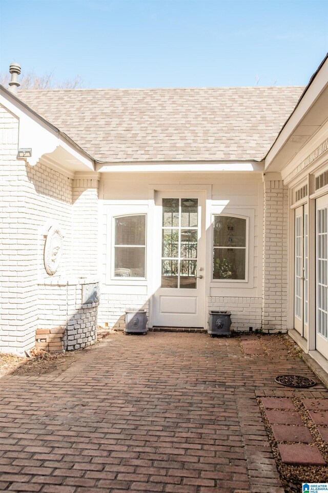 view of exterior entry featuring a patio area