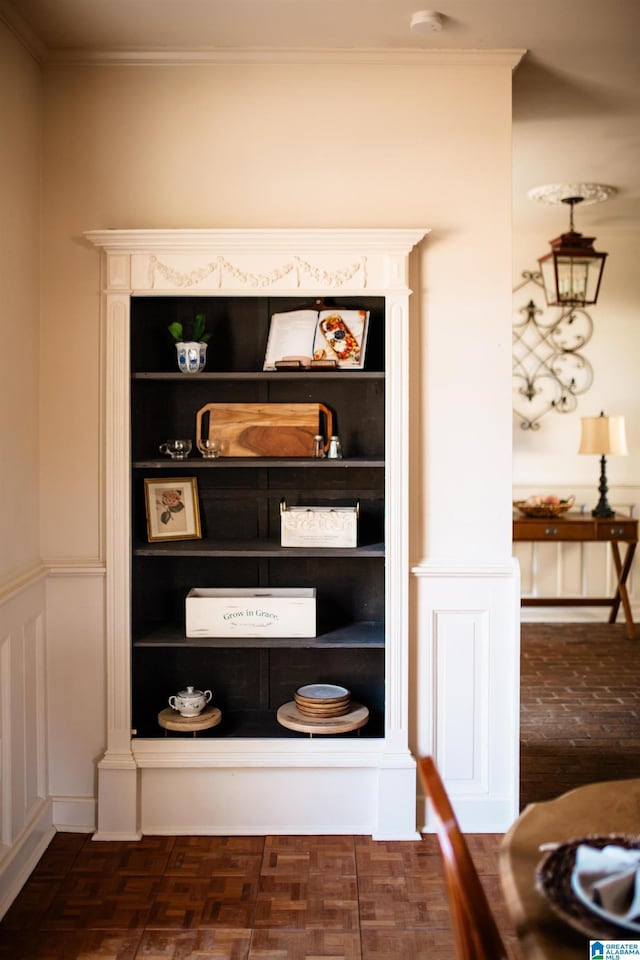 interior details with crown molding and parquet floors